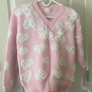 Cute pink sweater with crochet clouds and lace cuff